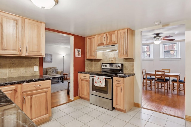 kitchen featuring light brown cabinets, backsplash, stainless steel range with electric cooktop, ceiling fan, and light tile patterned flooring