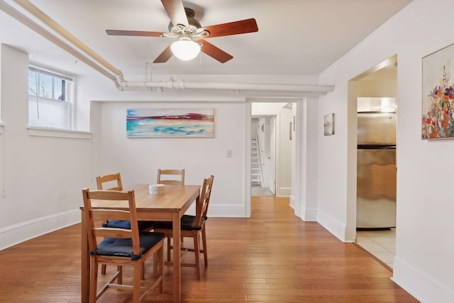 dining area with ceiling fan and hardwood / wood-style floors