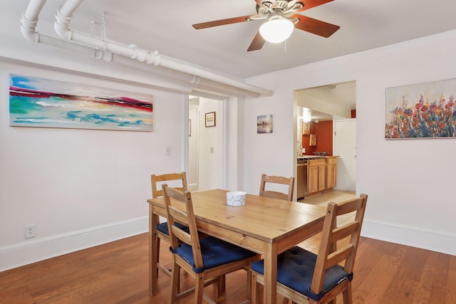 dining room with ceiling fan and hardwood / wood-style flooring