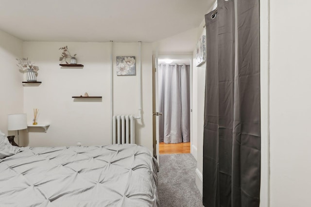 bedroom with carpet and radiator heating unit