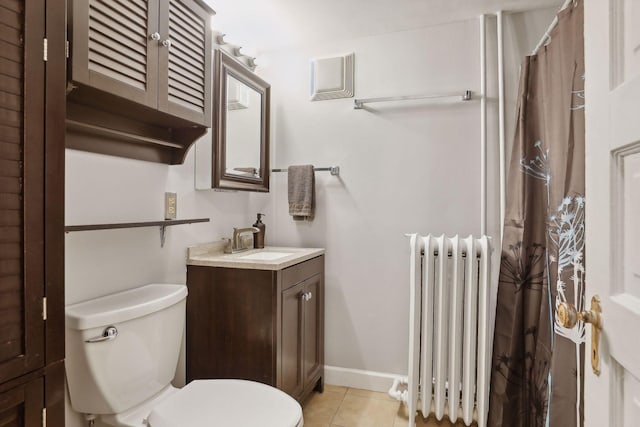 bathroom with toilet, radiator heating unit, vanity, and tile patterned floors