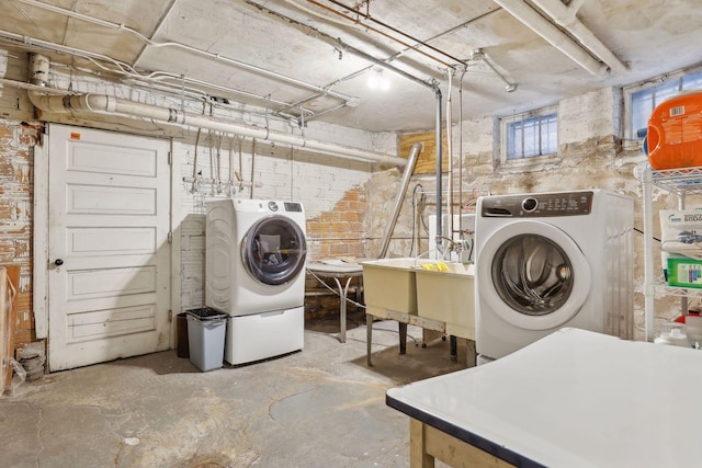 laundry room featuring washing machine and dryer and sink