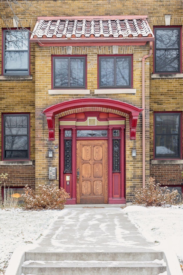 view of snow covered property entrance