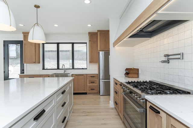 kitchen with white cabinetry, hanging light fixtures, custom exhaust hood, light stone counters, and stainless steel appliances