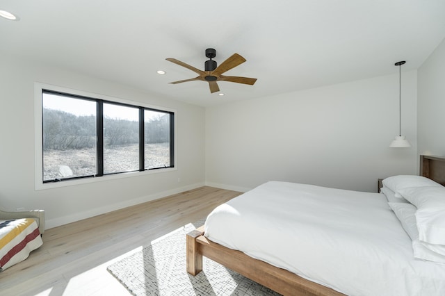 bedroom featuring ceiling fan and light hardwood / wood-style floors