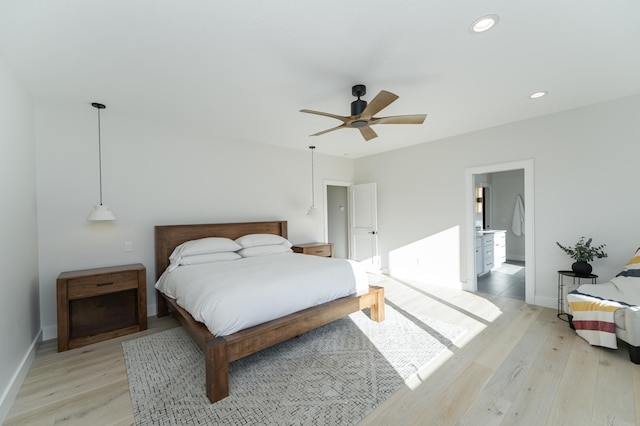 bedroom with light hardwood / wood-style flooring and ceiling fan