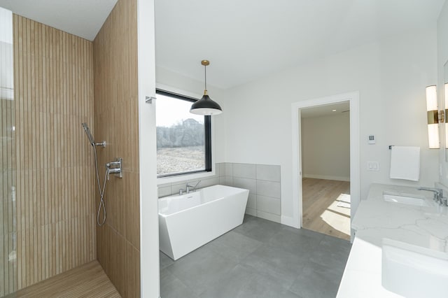 bathroom with vanity, separate shower and tub, and tile walls