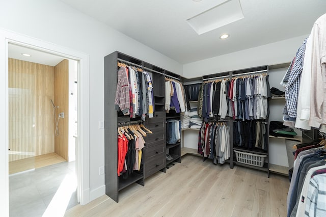 walk in closet with light wood-type flooring