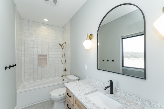 full bathroom with vanity, toilet, tiled shower / bath combo, and tile patterned flooring