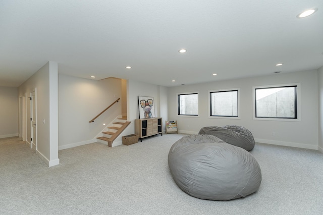 living area featuring light carpet