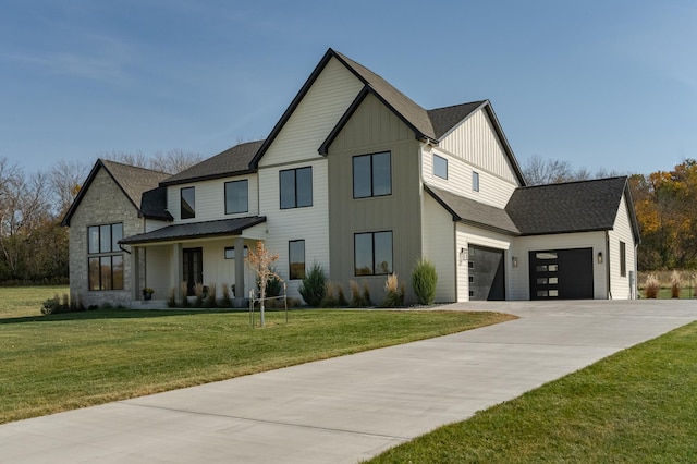 modern farmhouse featuring a garage and a front yard