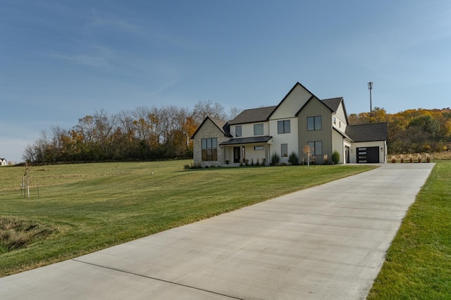 view of front of property with a garage and a front lawn