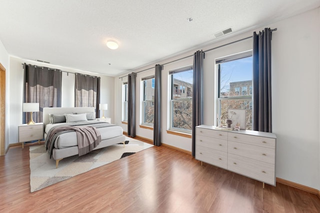 bedroom featuring a textured ceiling and hardwood / wood-style flooring