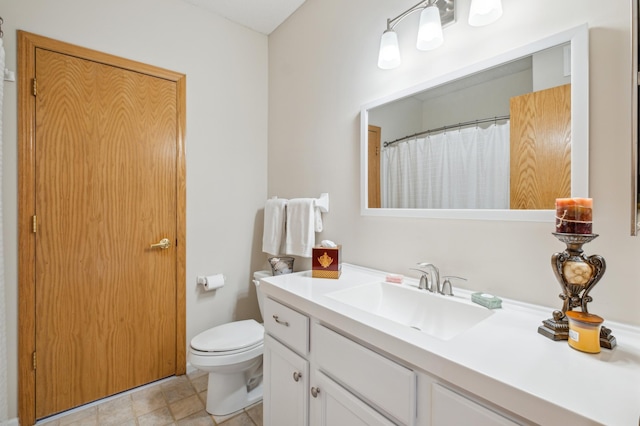 bathroom featuring tile patterned floors, vanity, and toilet