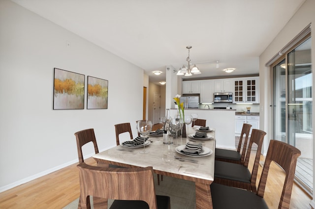 dining room featuring a chandelier and light hardwood / wood-style floors