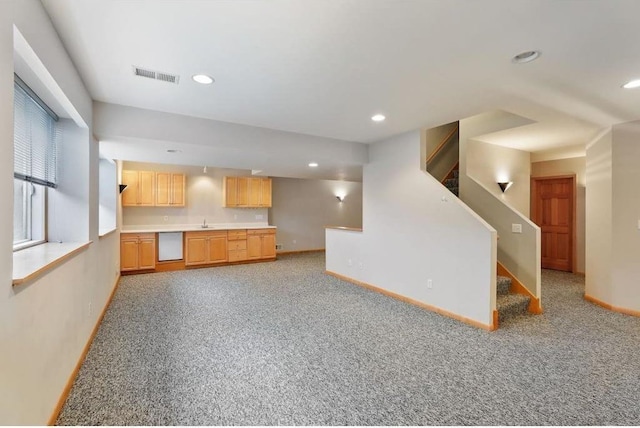 unfurnished living room with light carpet and sink