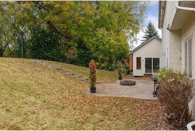 view of yard featuring a patio area and an outdoor fire pit