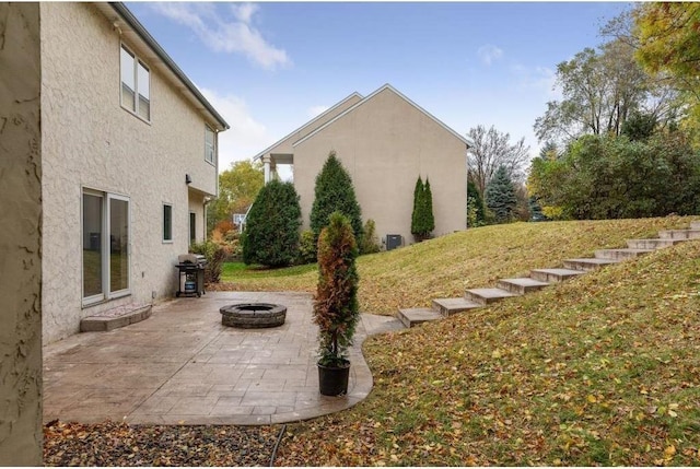 view of yard with a fire pit and a patio area