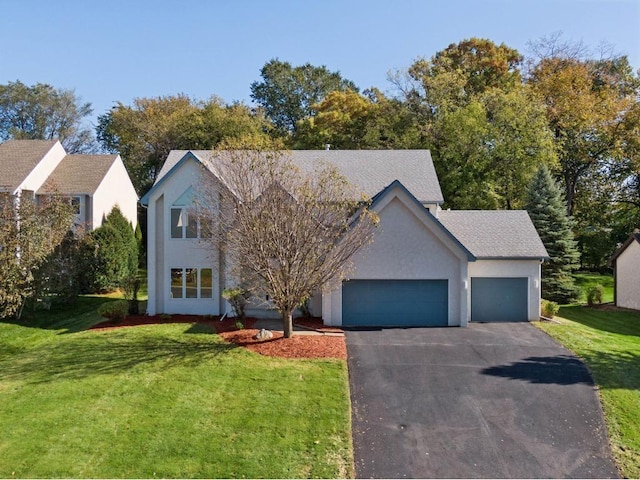 view of front of house featuring a garage and a front lawn