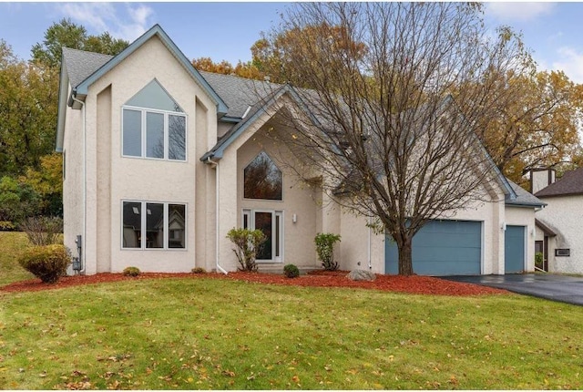 view of front of property featuring a garage and a front lawn