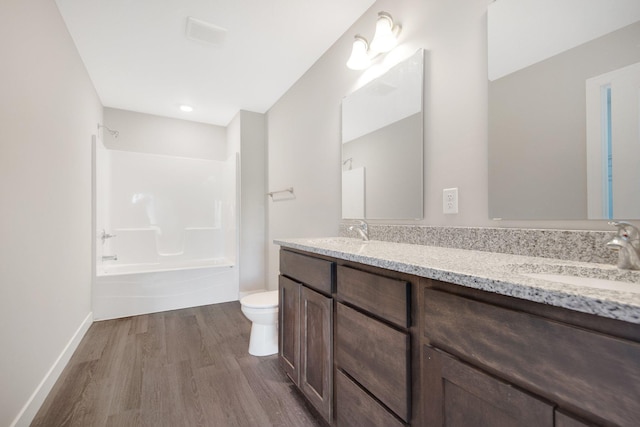 full bathroom with hardwood / wood-style flooring, vanity, toilet, and bathing tub / shower combination