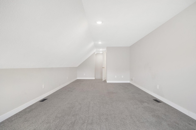 additional living space with lofted ceiling and carpet floors