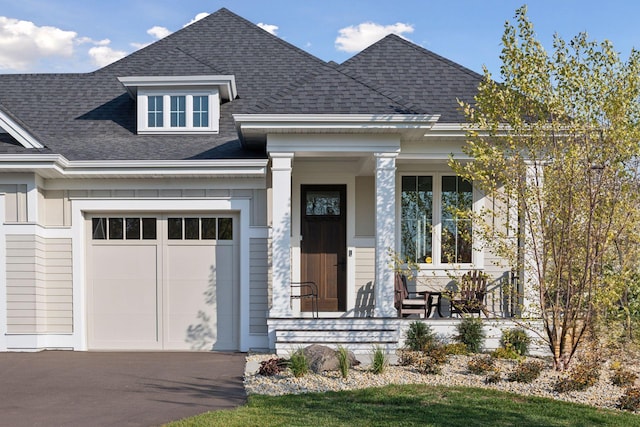 view of front of home featuring a porch and a garage