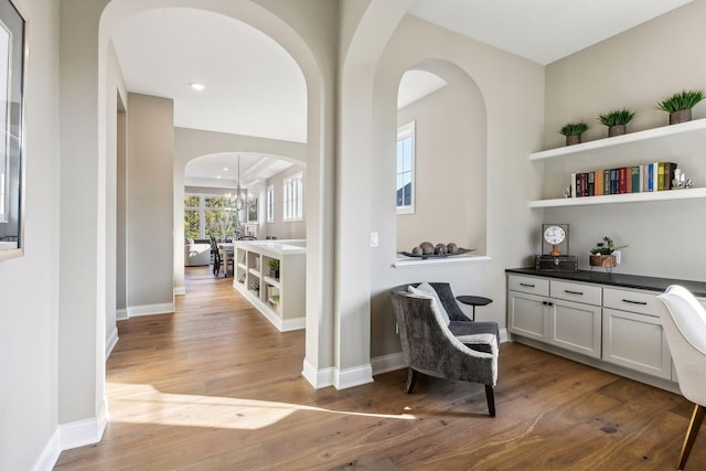 interior space with wood-type flooring and an inviting chandelier