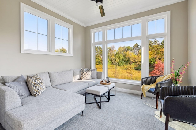 sunroom / solarium with ceiling fan, plenty of natural light, and wooden ceiling