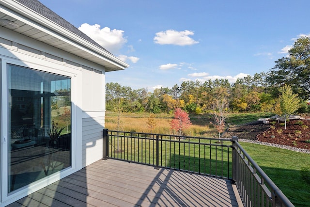 wooden deck featuring a yard