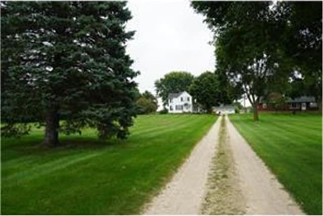 view of property's community with a lawn