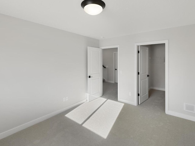 unfurnished bedroom featuring carpet floors and a closet