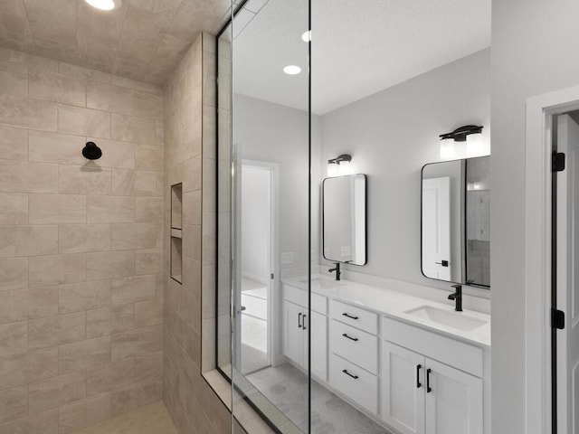 19461 Everglade Path, Farmington, MN 55024 - bathroom with tiled shower, double vanity, and recessed lighting