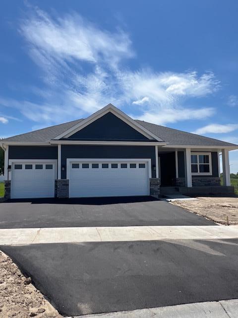 19461 Everglade Path, Farmington, MN 55024 - view of front of home featuring a garage, driveway, and stone siding
