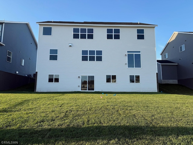 rear view of property with a yard