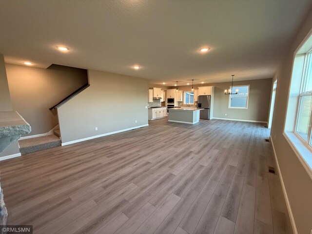 unfurnished living room with light hardwood / wood-style flooring