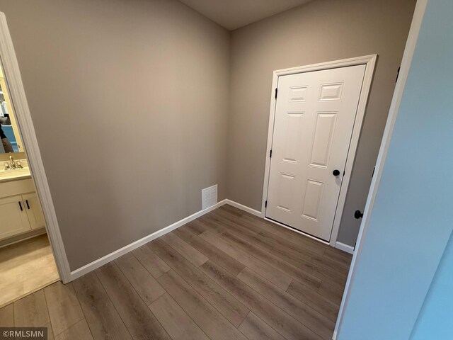 entryway with light hardwood / wood-style flooring and sink