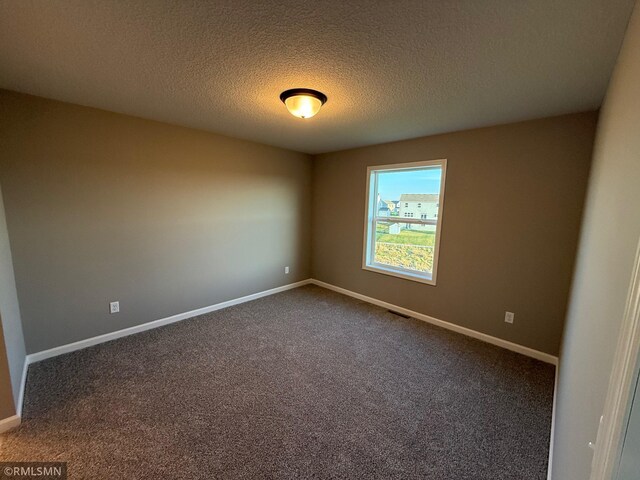 2656 Ivy Ave NE, Saint Michael, MN 55376 - unfurnished room with dark colored carpet, a textured ceiling, and baseboards