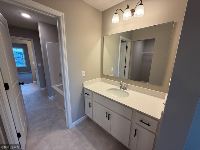 bathroom with vanity and a textured ceiling