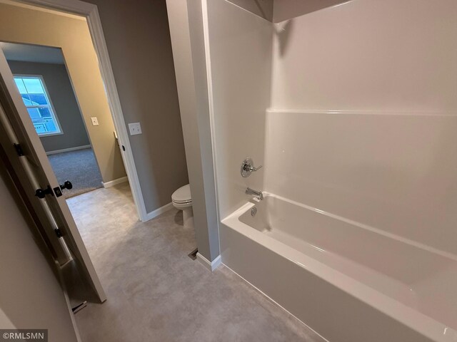 bathroom with toilet and tub / shower combination