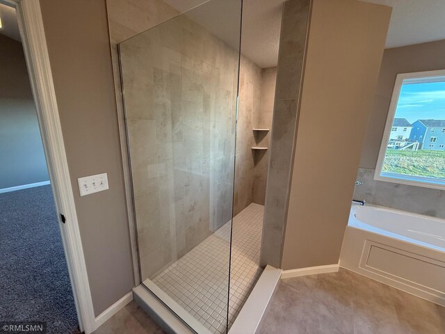 bathroom featuring separate shower and tub