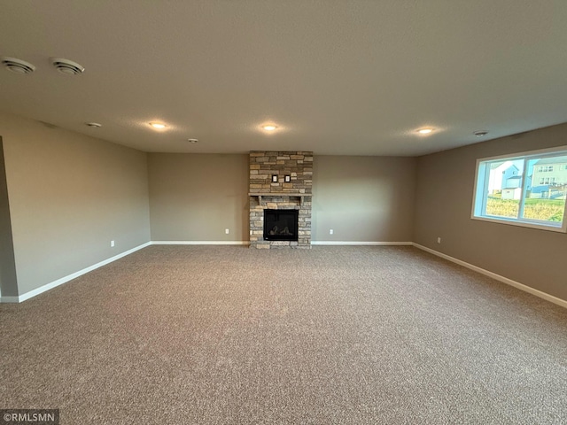 unfurnished living room featuring carpet flooring and a fireplace