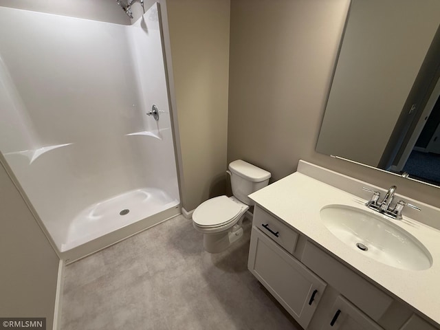 bathroom featuring a shower, vanity, and toilet