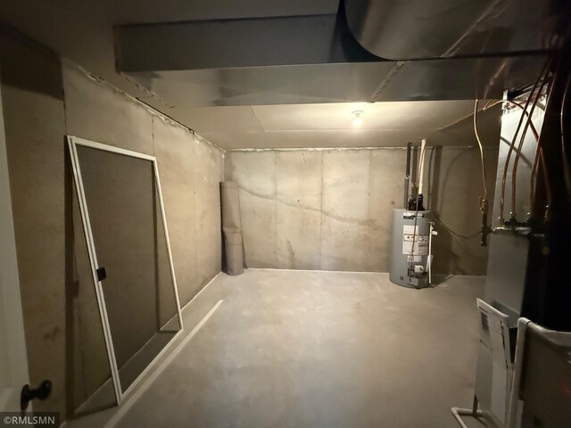 basement featuring heating unit and water heater