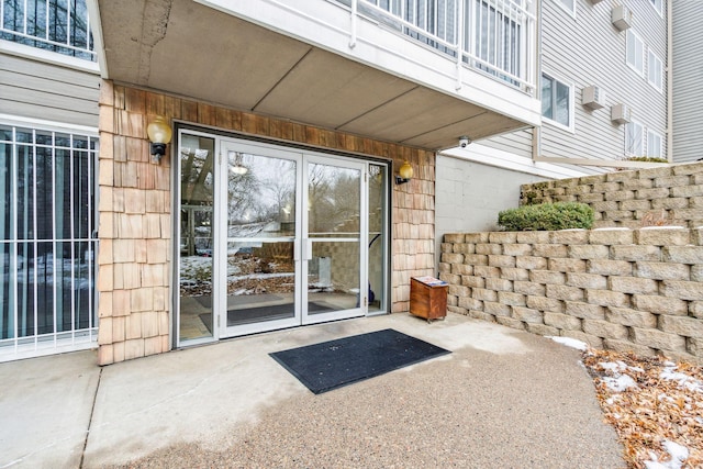 view of exterior entry with a patio area