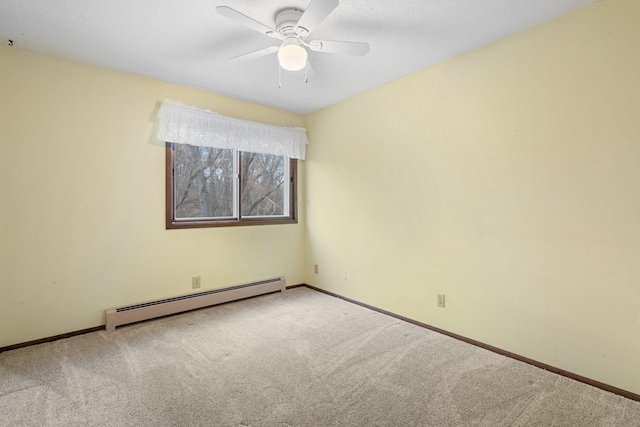 carpeted spare room with baseboard heating and ceiling fan