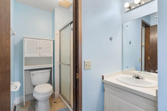 bathroom with toilet, an enclosed shower, baseboard heating, and vanity