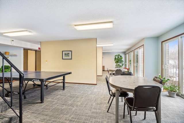 game room with carpet and a textured ceiling