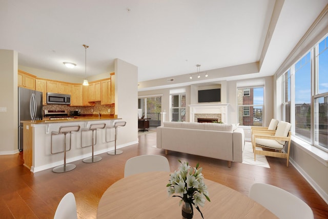 living room with plenty of natural light and light hardwood / wood-style floors