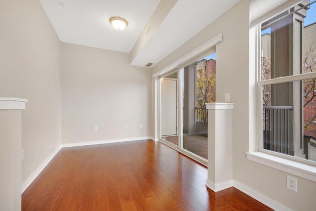 unfurnished room with hardwood / wood-style flooring